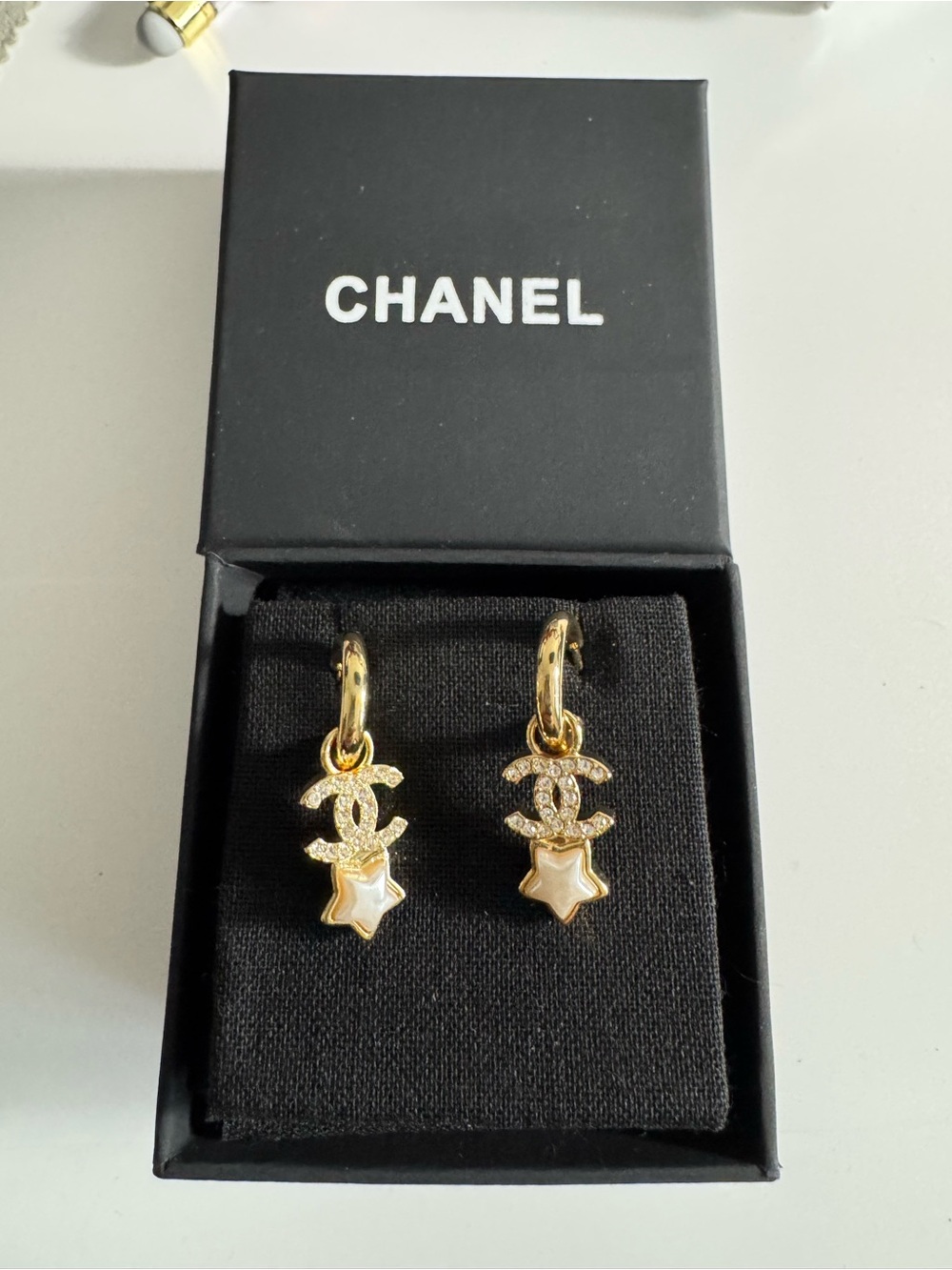 CHANEL Gold CC Star Drop Earrings with White Enamel Stars